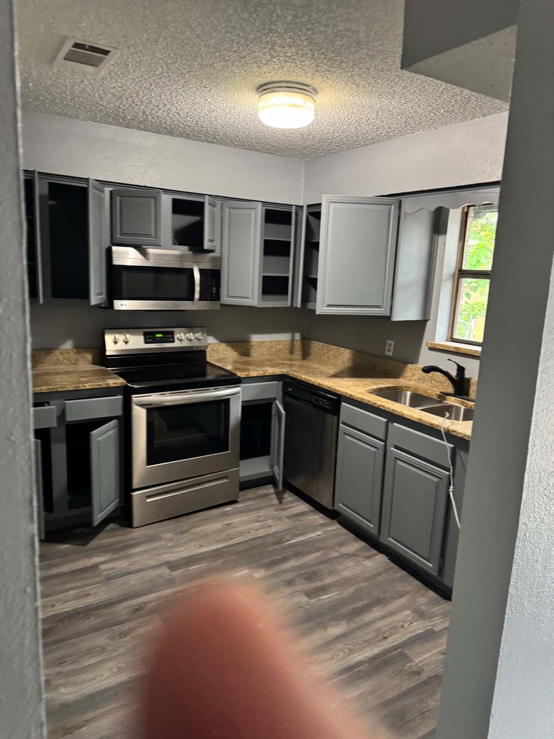 Updated kitchen with stainless steel appliances and granite counters